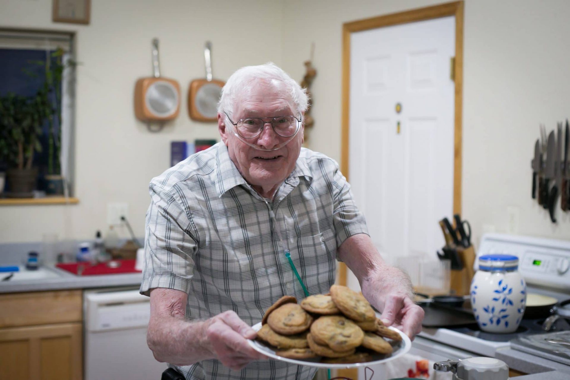 Ray’s chocolate chip cookies are legendary. Here he is shown serving a plate of cookies with a huge smile on his face.