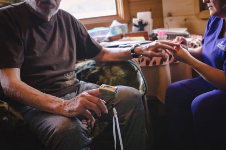 Hospice patient having his O2 reading done with a pulse oximeter